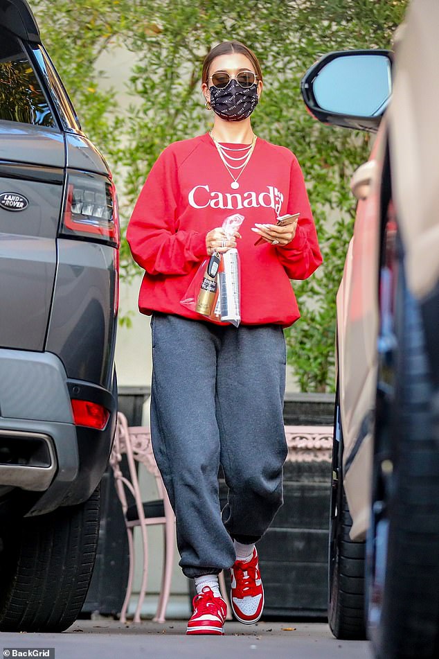 Pride: Hayley Bieber wore a red Canada Groeneck sweater during a salon tour in Los Angeles on Wednesday to represent her husband Justin Bieber's home country
