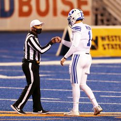 BYU Cookers Quarterback Sock Wilson (1) Fist-pumps with an officer before playing BYU and Boise State at the Albertson Stadium in Boise on Friday, November 6, 2020.