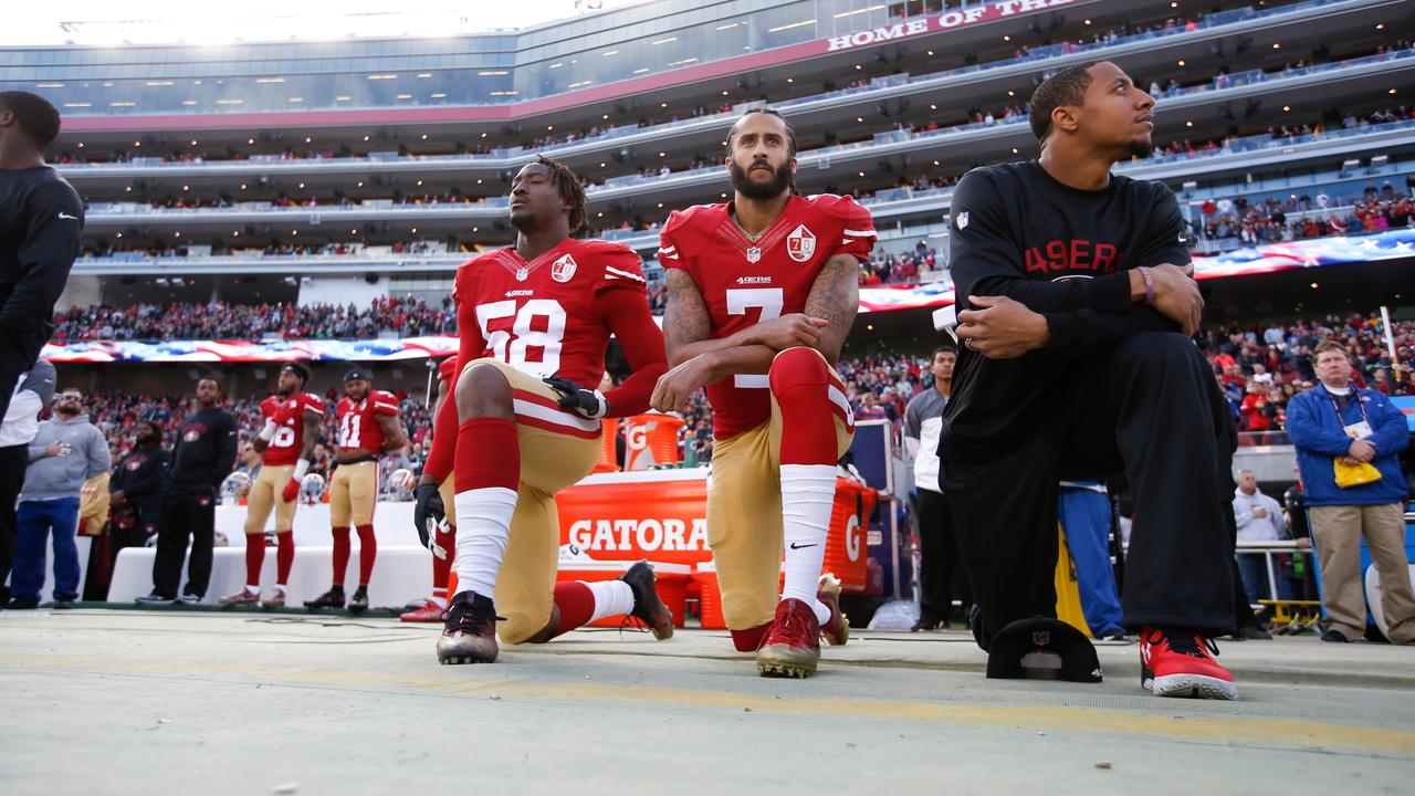 Colin Kaepernick (center) also took a knee before his final NFL game on January 1, 2017.