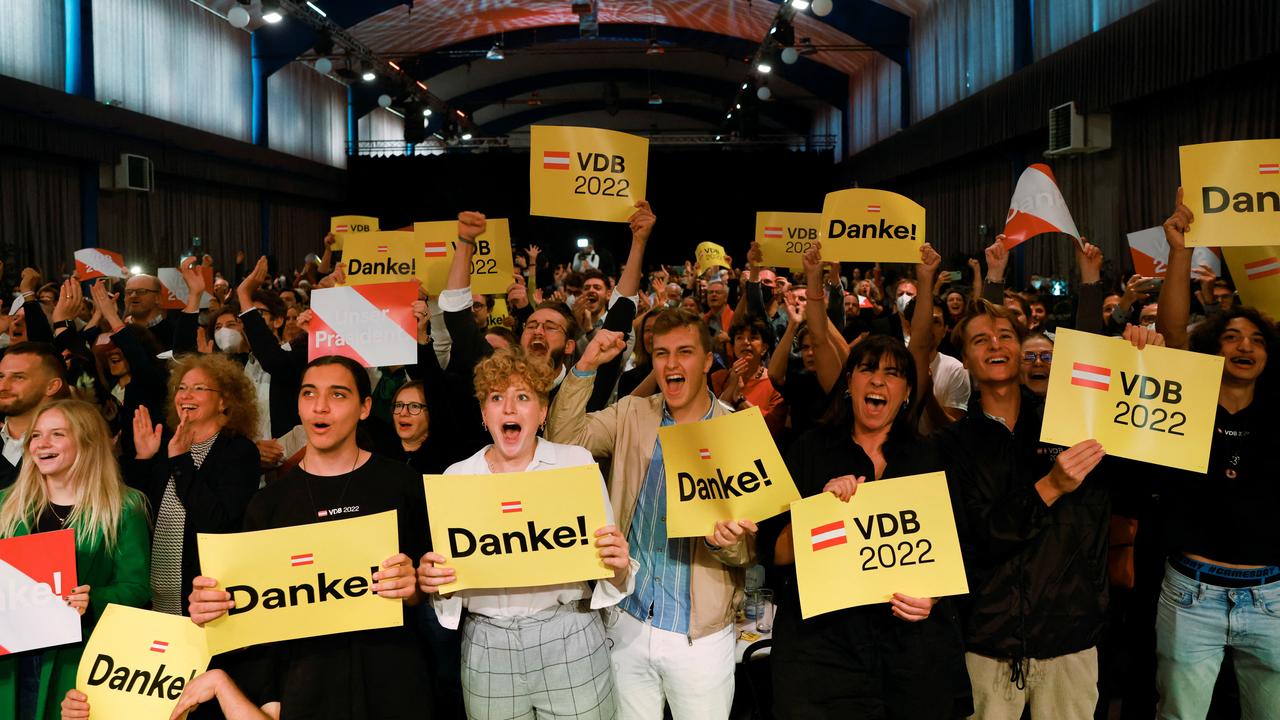 Van der Bellen supporters cheer as the forecast is announced in the capital Vienna.