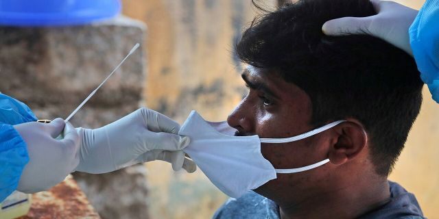 On Sunday, September 13, 2020, a health worker takes a sample of a nasal swab to test for COVID-19 in Hyderabad, India.  India's corona virus cases are now the second highest in the world and only behind the United States.  (AP Photo / Mahesh Kumar A.)