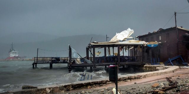 On Friday, September 18, 2020, waves break at a seaside restaurant during a storm at the port of Argostoli on the Ionian island of Kefalonia in western Greece.