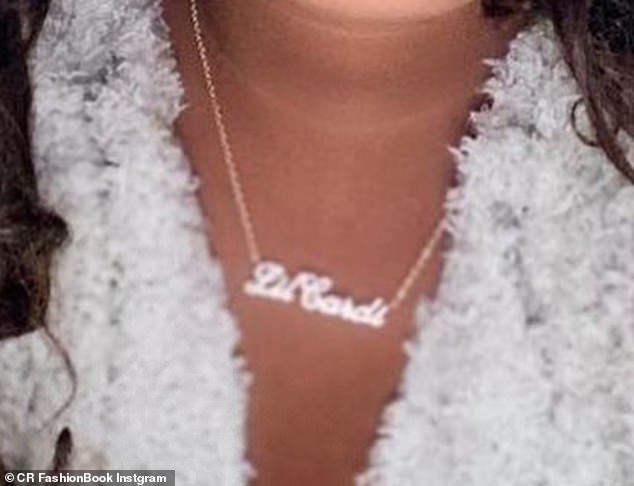Baby Bling: A close-up of the 39-year-old reality star's privileged princess reveals that she is waving a 'Lil Cardi' nameplate necklace