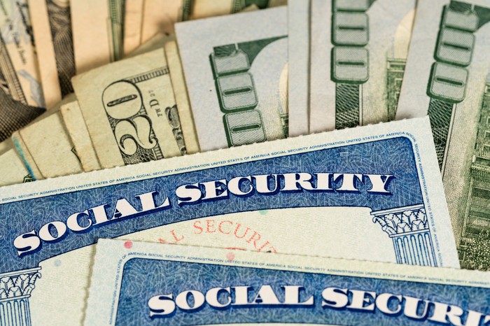 Two Social Security cards lie on top of the devalued layer.