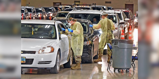 Motorists line up for a drive-up corona virus test at an unspecified location.  (Associated Press)