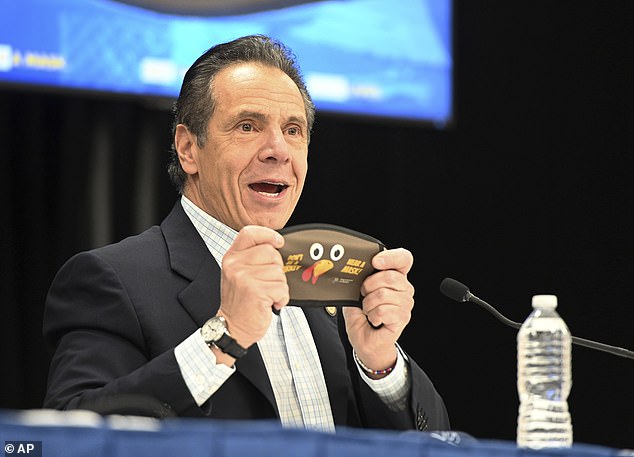 Cuomo holds a new Thanksgiving-themed mask at Wyndonch-Wheatley Heights Ambulance Corp during his daily Corona virus conference