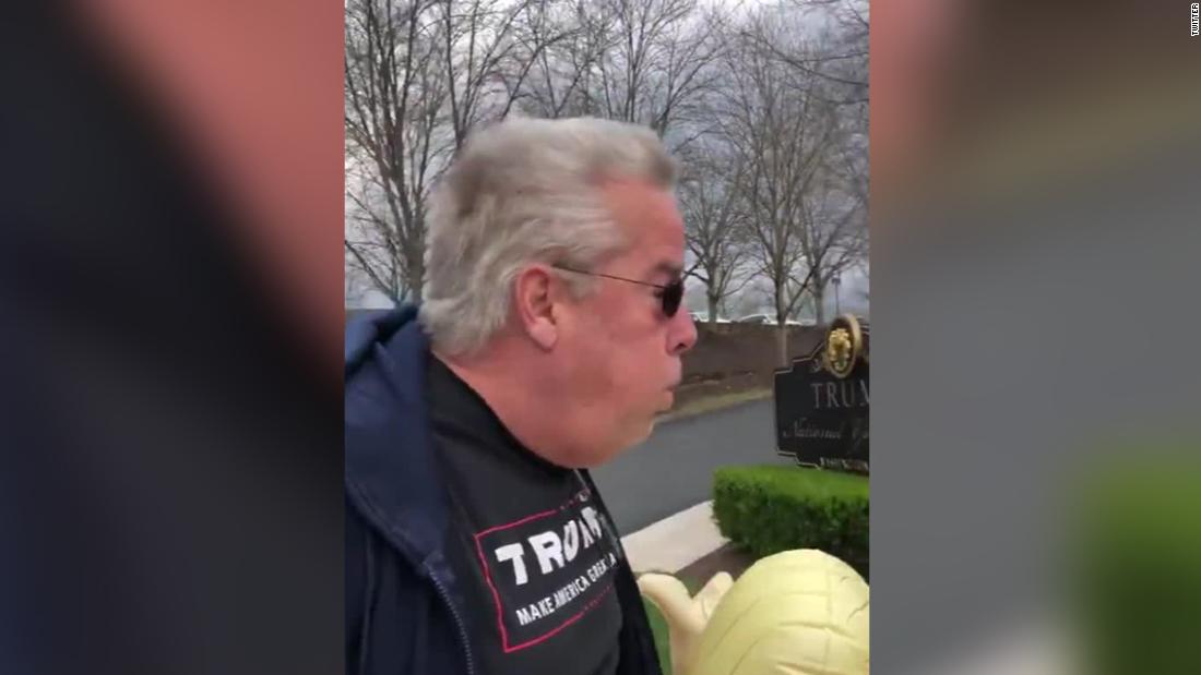 A man in Trump gear faces a simple assault charge after he saw Trump breathing on women outside a golf club.