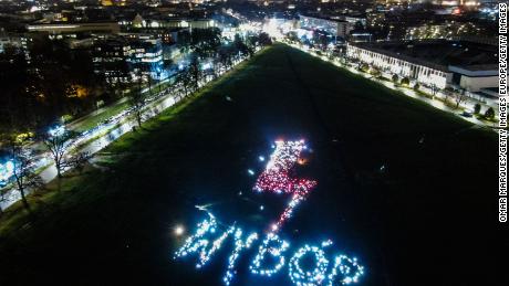 Protesters in Krakow use their smartphones and lights to pronounce WYBÓR (choice, in English) on Tuesday.