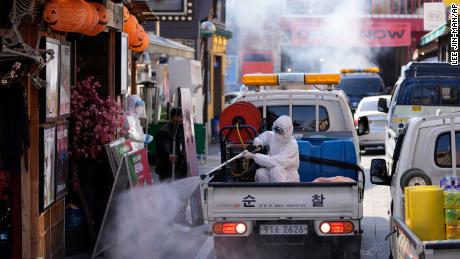 On Friday, October 29, a local health official wearing safety gear in Seoul, South Korea disinfected storefronts as a precaution against the coronavirus.