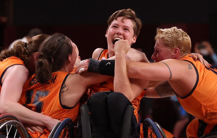 Wheelchair basketball players are celebrating.