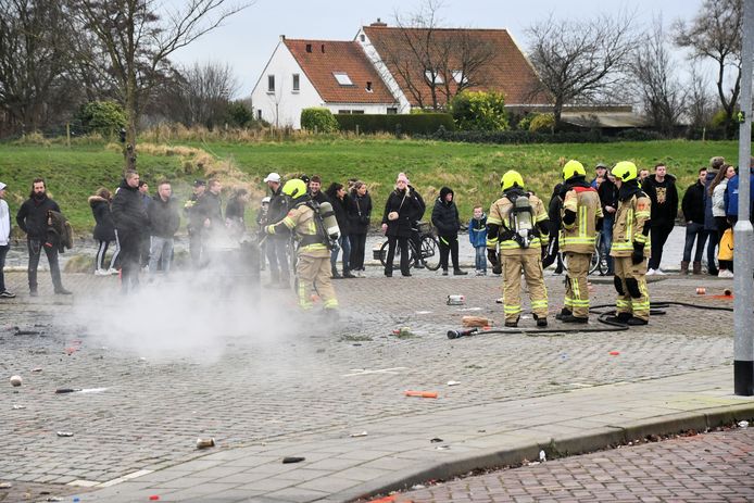 Firefighters extinguish a fire in a metal barrel on the Zuidwal in Arnemuiden.