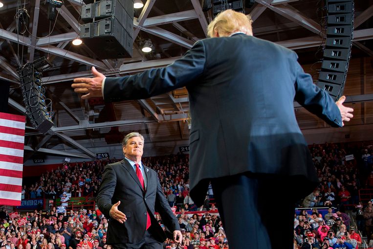 Donald Trump (right) greets Sean Hannity at a 2018 campaign rally. AFP Image
