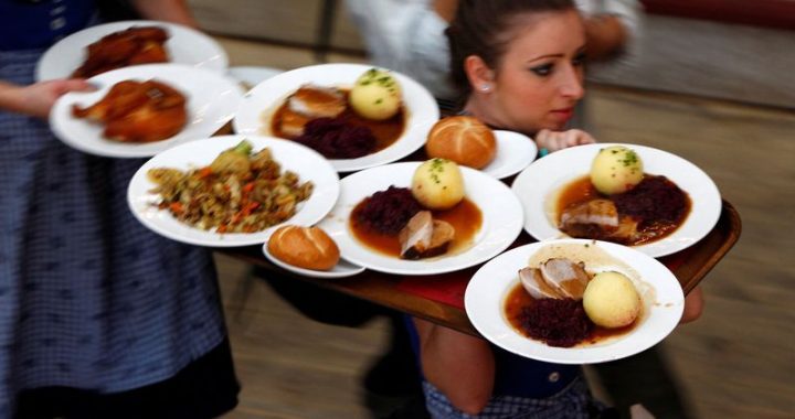 FILE PHOTO: Waitress carries meals during Oktoberfest in Munich