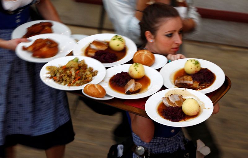 FILE PHOTO: Waitress carries meals during Oktoberfest in Munich