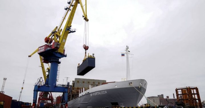 FILE PHOTO: A crane lifts a shipping container at a commercial port in Kaliningrad