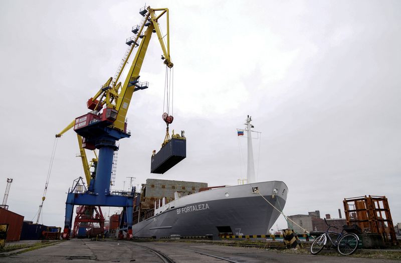 FILE PHOTO: A crane lifts a shipping container at a commercial port in Kaliningrad