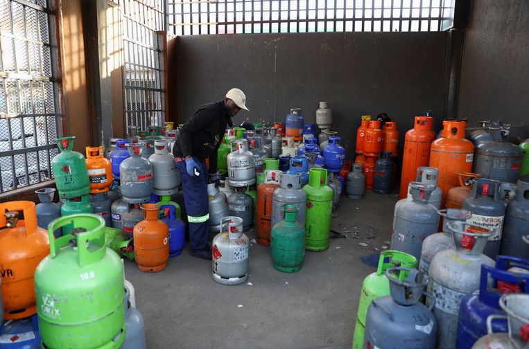 A worker sorts liquefied petroleum gas cylinders in Soweto, South Africa.  Image courtesy of Reuters