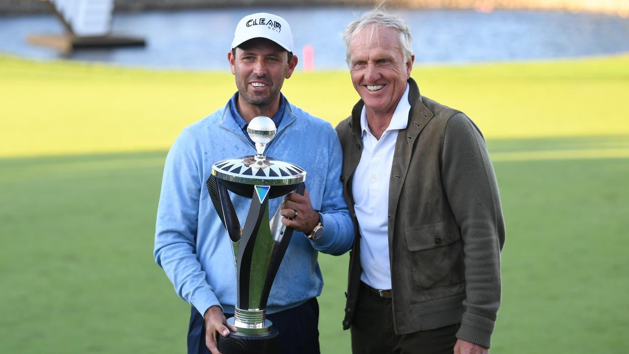 Charl Schwartzel (left) and Greg Norman (right) pose with the trophy after winning the LIV Golf Invitational Series in London.