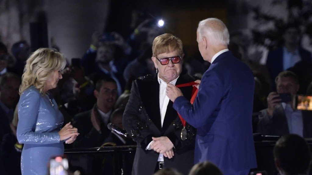 President Biden presents the award to Elton John