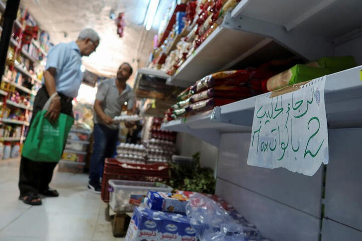 A customer stands inside a grocery store in Tunis