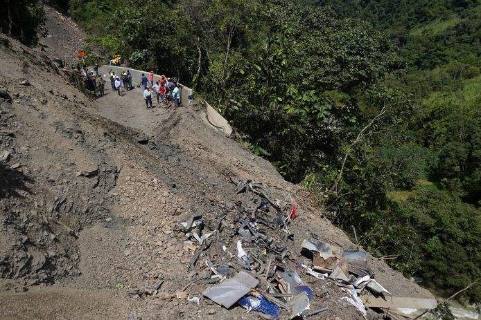 The wreckage of the vehicle can be seen at the site of the landslide.
